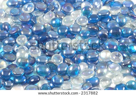 A collection of blue and clear glass beads suitable as a background