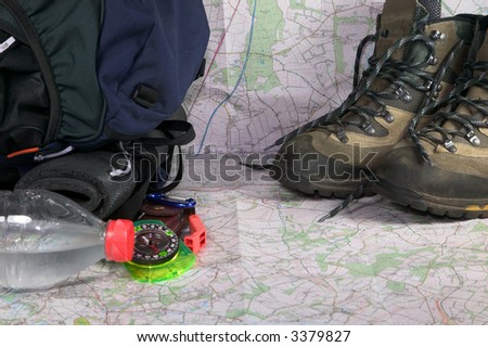 Rucksack, boots and other items for planning an adventure trip.