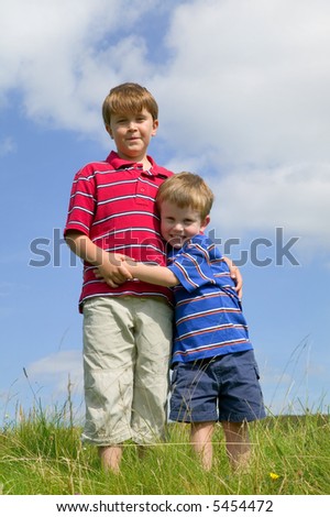 Two brothers in a meadow on a bright summer\'s day.