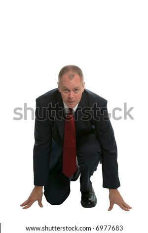 Businessman in a starting position about to face the competition.