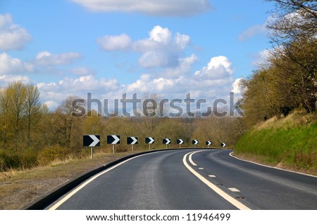 Approaching a sharp bend on a rural road with views of the countryside.