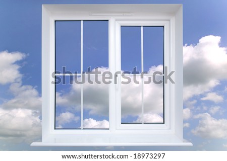 Window frame against a blue cloudy sky