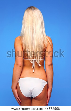 Rear view of a young blond woman wearing a white bikini