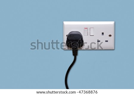 Double electrical power socket and single plug switched on, blue background.