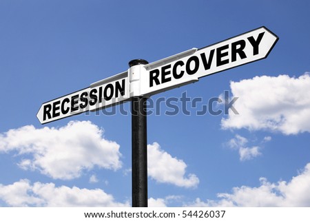Signpost with the words Recession and Recovery against a blue cloudy sky