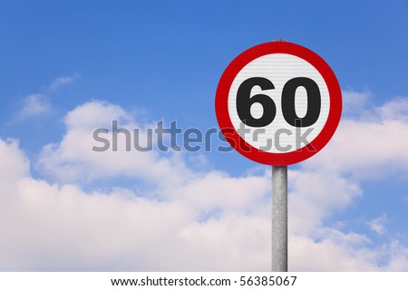A round roadsign with the number 60 on it against a blue cloudy sky.