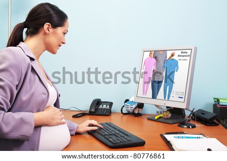 Photo of a pregnant businesswoman in her office shopping online for baby clothes. The screenshot is a mock up and is one of my shots. Screen has a clipping path to add your own image or text.