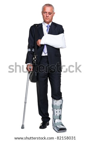 Photo of a badly injured businessman walking on cructhes carrying a briefcase, isolated on a white background.