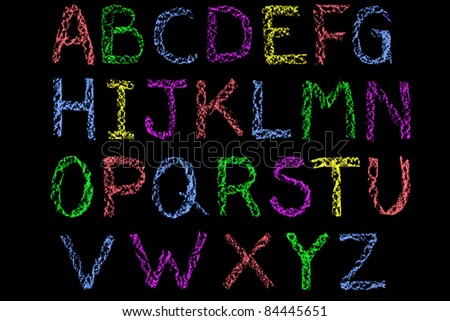Handwritten letters of the alphabet written on a blackboard then cleaned up during editing, coloured  and placed on a black background.