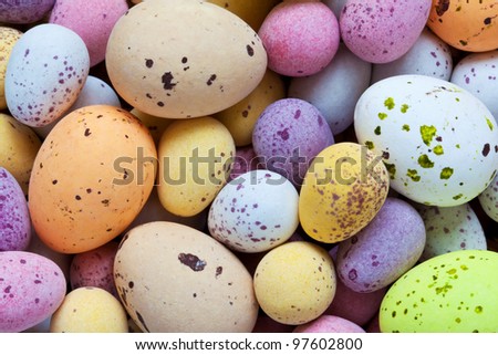 Still life photo of lots of  colourful speckled candy covered chocolate easter eggs