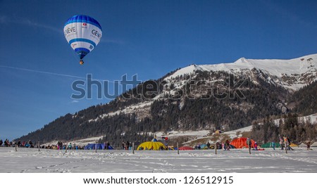 CHATEAU D'OEX, SWITZERLAND - JANUARY 26: Hot air balloons at the 35th International Hot Air Balloon Festival, Switzerland on January 26, 2013 in Chateau d'Oex, Switzerland.