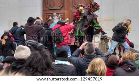 ANNECY, FRANCE - FEBRUARY 23: Crowds and photographers taking pictures of the participants at the 17th Edition of the Annual Carnival Venitian d\' Annecy on February 23,2013 in Annecy, France.