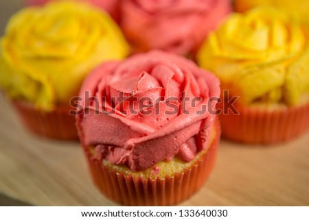 Rose shape cupcakes on a pastry board