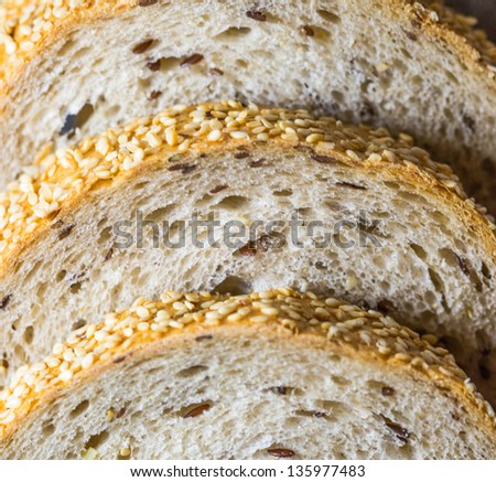 Pieces of sesame seed bread on a pastry board