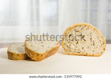 Pieces of sesame seed bread on a pastry board