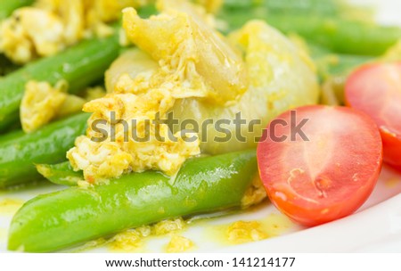 Stir fried green beans with scrambled eggs, and cherry tomato.