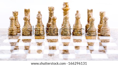 Stone made chess set over white background
