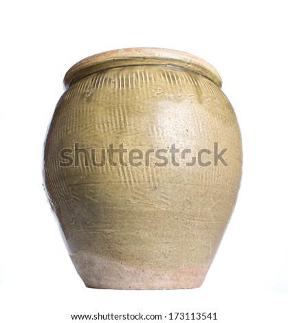 Old earthenware storage jar over white background