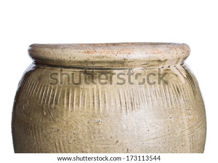 Old earthenware storage jar over white background