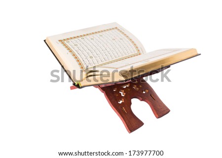The holy Quran on a wooden book stand over white background The holy Quran on a wooden book stand over white background