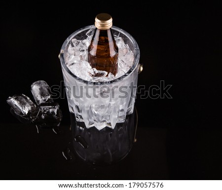 A bottle of drink kept chilled in a crystal made ice bucket