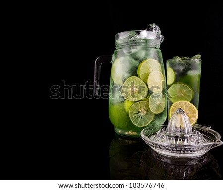 Fresh and refreshing lime juice over black background