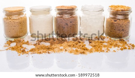 Muscovado sugar, brown sugar, coconut sugar, rock sugar and refined sugar in glass container