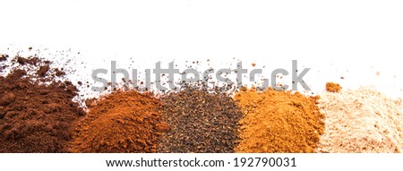 Cocoa powder, ground coffee and dried tea leaves in a white ceramic container over white background