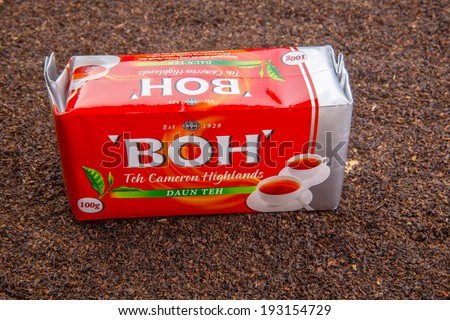 KUALA LUMPUR, MALAYSIA - MAY 17TH, 2014: A pack of BOH TEA over dried tea leaves. Founded in 1929, BOH Plantations Sdn. Bhd. is the largest black tea manufacturer in Malaysia.