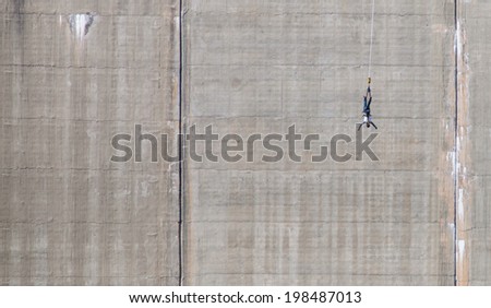 LOCARNO DAM, SWITZERLAND - SEPTEMBER 15TH, 2012. Bungee jumping along the Locarno Dam concrete wall. The Locarno Dam is a popular bungee jumping venue in the Swiss Alps.