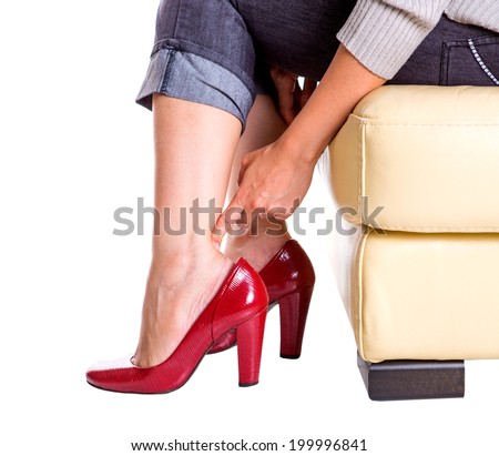 Lady rubbing her hurt heel wearing high heel shoes