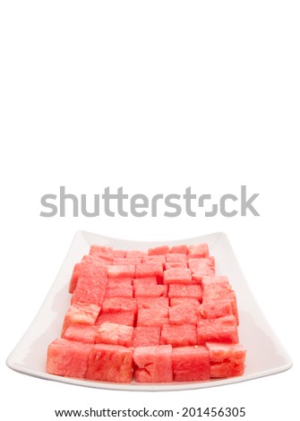 Bite size watermelon on a white plate over white background