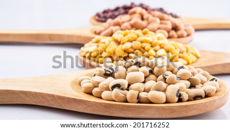 Peanut, dal lentils, black eye bean and adzuki bean on wooden spoon