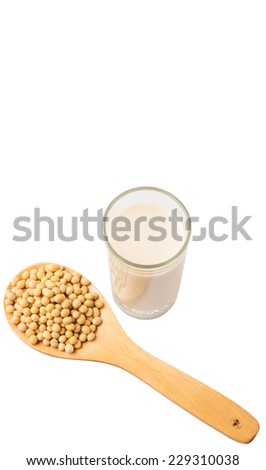 Soybean on wooden spoon with a glass of soybean milk