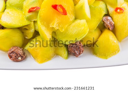 Close up view of pickled young mango with dried tamarind and chili slices