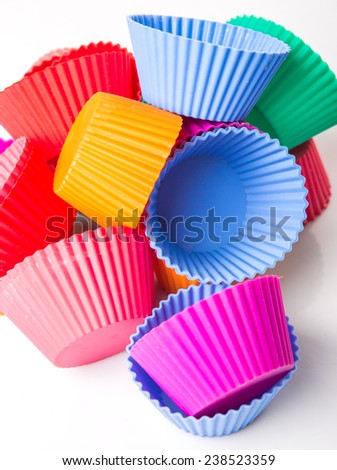 Various colors of silicone cupcake silicone baking cups over white background