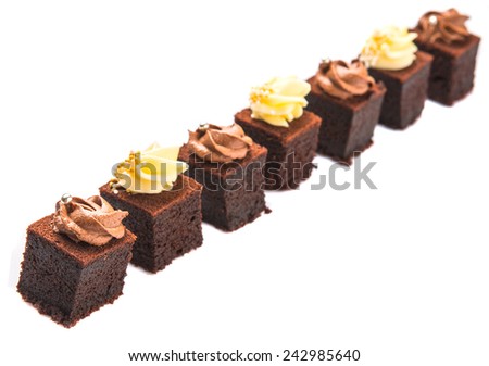 Bite sized chocolate cake with chocolate and cream cheese toppings