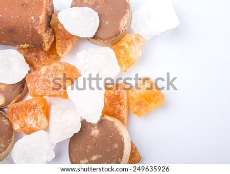Palm sugar, coconut sugar, sugar cane rock and white rock sugar over white background