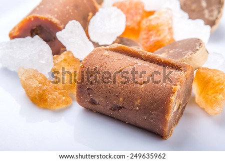 Palm sugar, coconut sugar, sugar cane rock and white rock sugar over white background