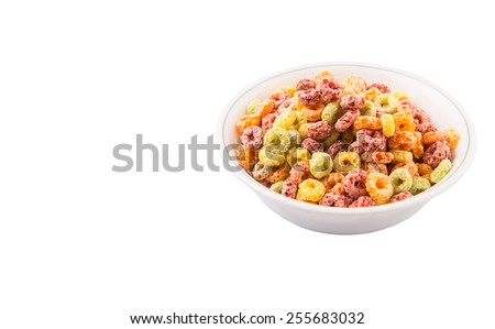 Colorful fruit flavored loops shaped cereal in a white bowl over white background
