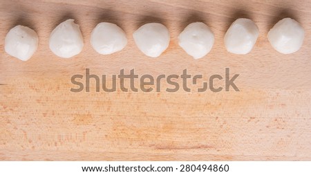 Raw white fish ball on a wooden surface