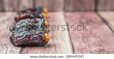 Date fruits over wooden background