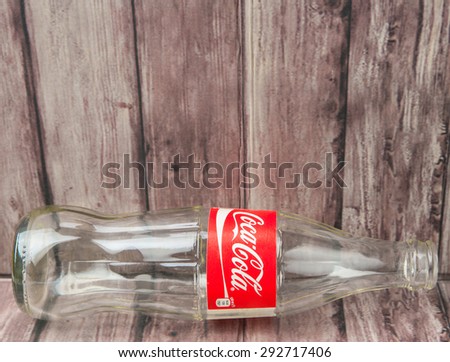 PUTRAJAYA, MALAYSIA - JULY 2ND, 2015. Empty Coca Cola bottle. Coca Cola drinks are produced and manufactured by The Coca-Cola Company, an American multinational beverage corporation.