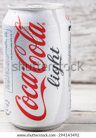 PUTRAJAYA, MALAYSIA - JULY 5TH, 2015. Coca Cola Light on weathered wood. Coca Cola drinks are produced and manufactured by The Coca-Cola Company, an American multinational beverage corporation.