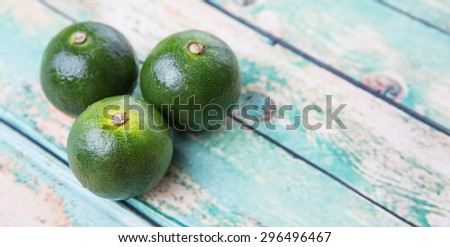 Calamansi citrus over weathered wooden background