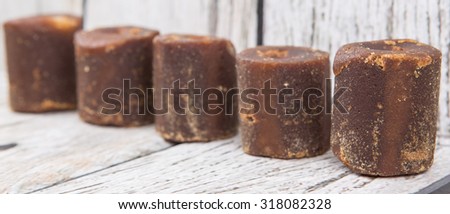 Brown coconut sugar over wooden background