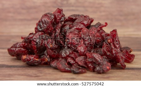Dried cranberries over wooden background