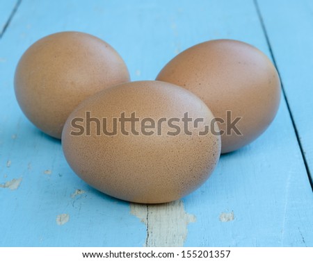 Chicken egg  on the blue background table.