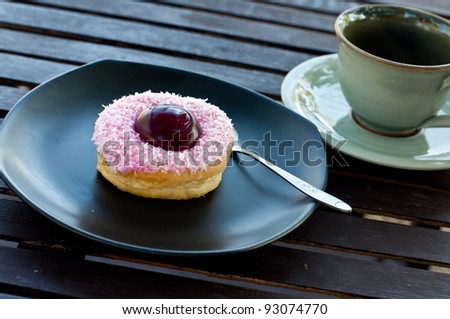 delicious  donut  on the disk in coffee break.