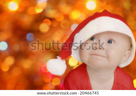 stock-photo-funny-baby-in-big-santa-claus-hat-on-bright-festive-background-space-for-text-20466745.jpg